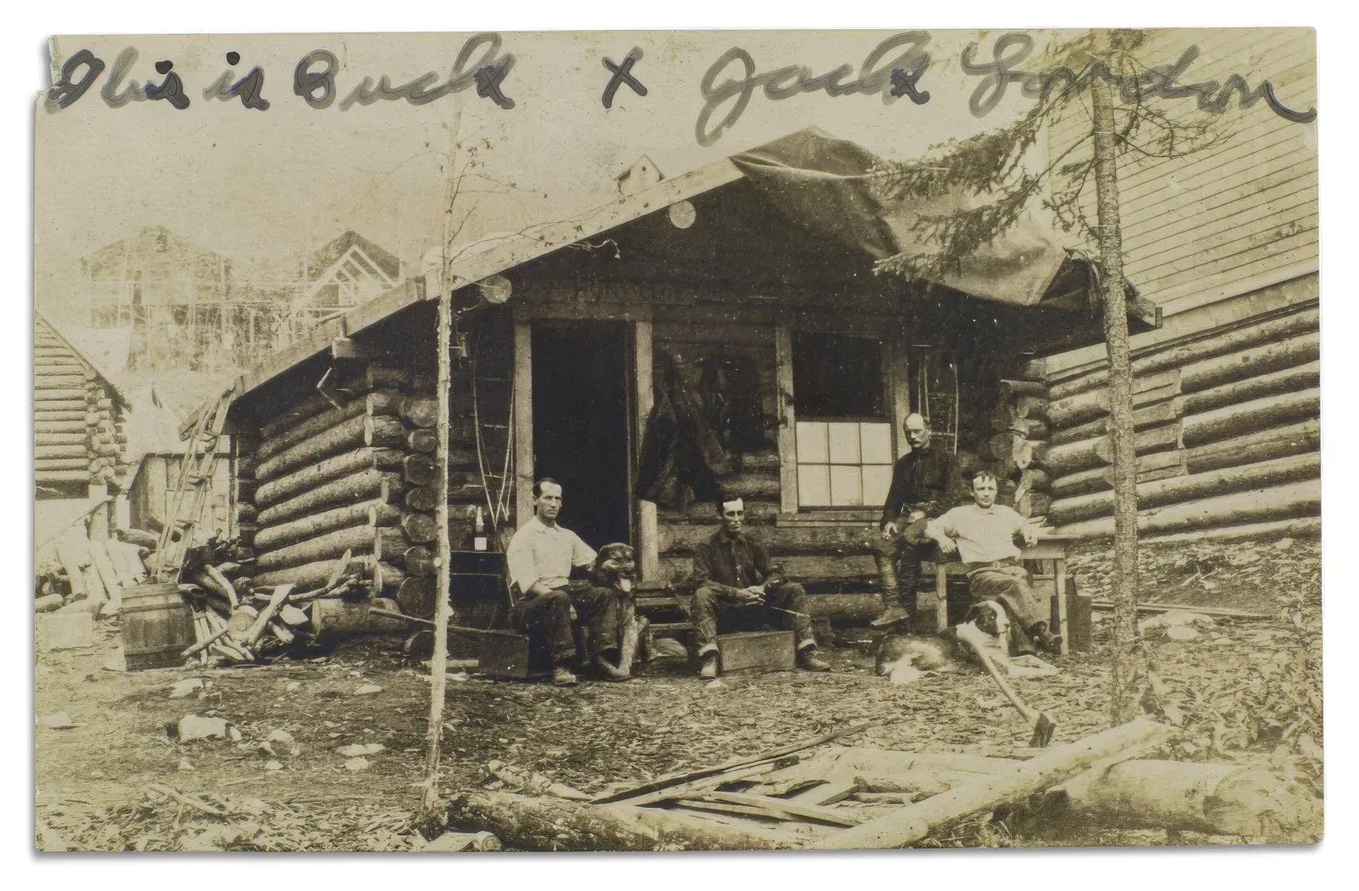 Четверо мужчин — Маршалл Бонд, Оливер Х. Р. Ла Фарж, Лайман Р. Колд и Стэнли Пирс — сидят в хижине со своими собаками. Тот пёс, что слева, стал прототипом Бака в «Зов предков». Подпись Лондона находится в верхней части фотографии. Коллекция Джека Лондона / Библиотека Хантингтона, Сан-Марино, Калифорния.